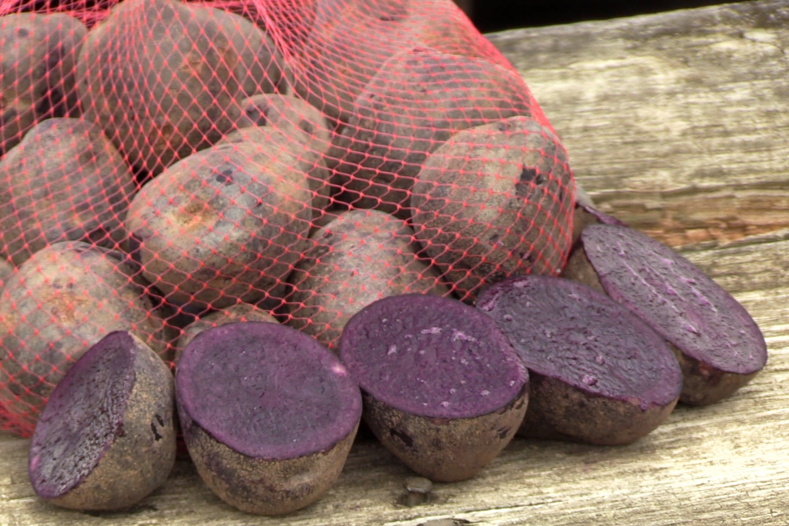 purple potatoes cut in half and in bag